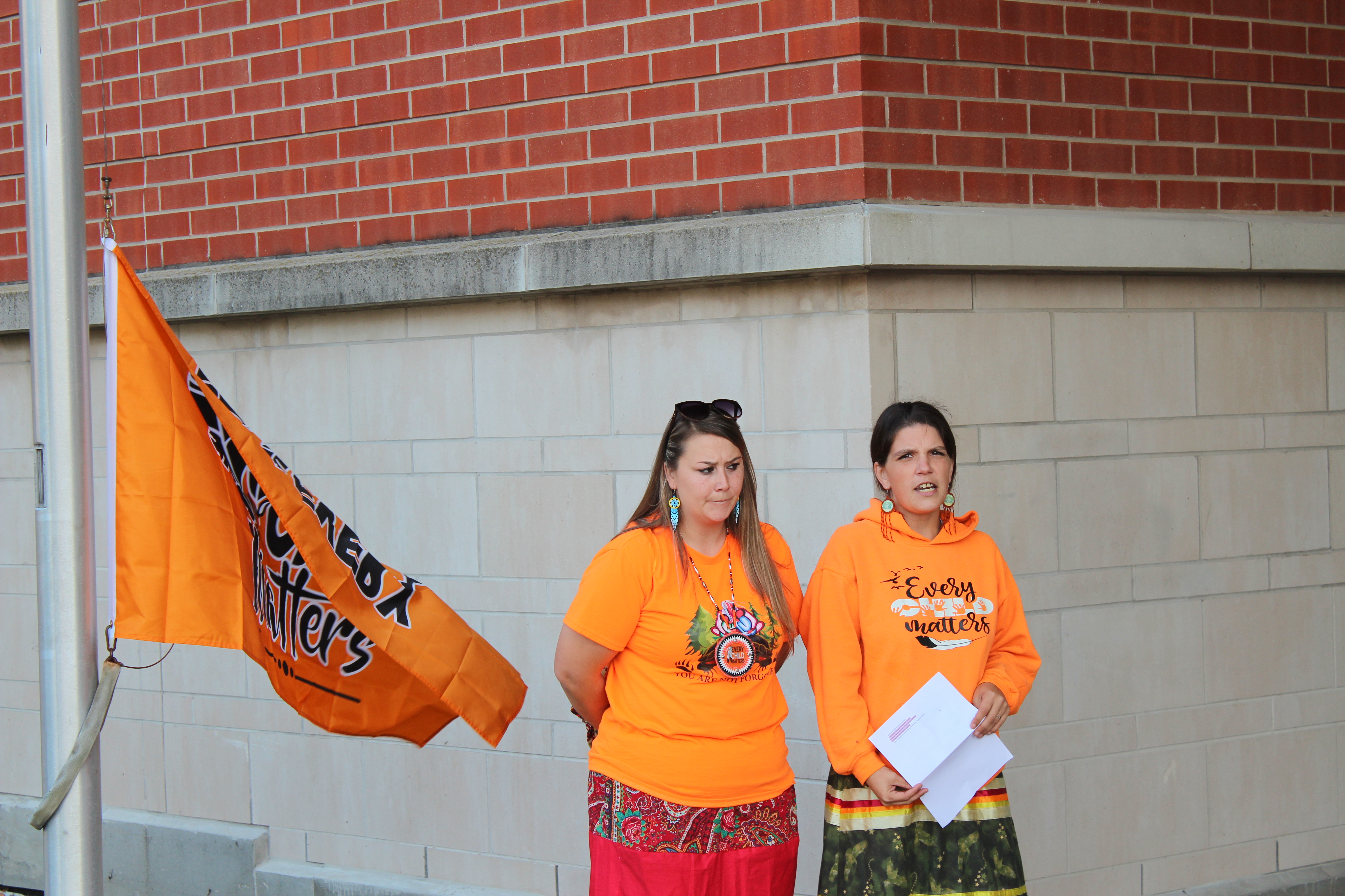 NDTR flag raising event with presenters speaking