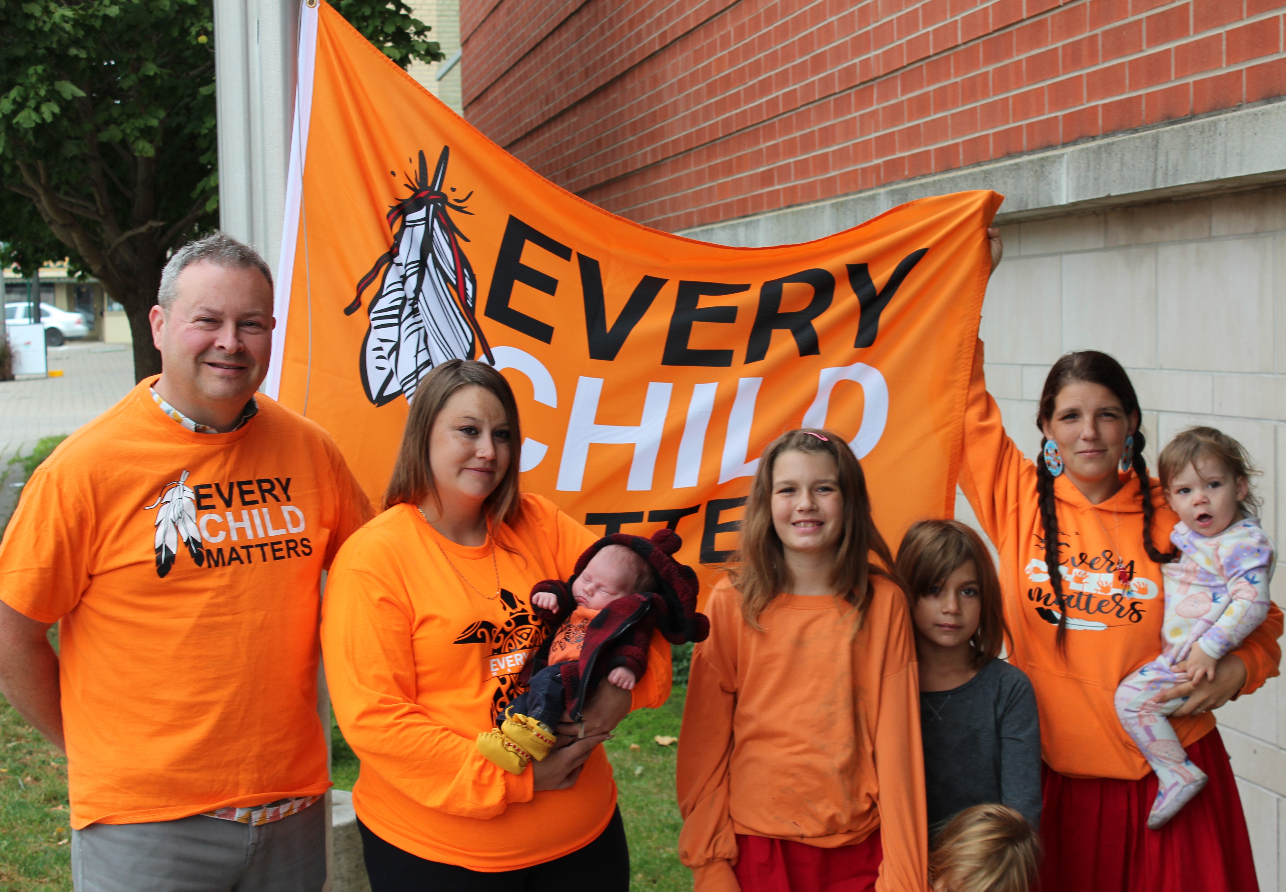 ISAN members pose with Every Child Matters flag